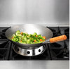 Twelve Mandarin woks with wooden handles, offering a comfortable grip for cooking large portions of stir-fry.


