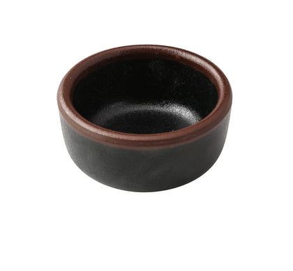 Yanco Sauce Dish NA-5002BK Made from high-quality melamine, this server is both durable and lightweight. Its round shape and break-resistant nature make it suitable for frequent use in commercial dining environments. This server is designed to be dishwasher safe, ensuring convenient and efficient cleaning, essential for high-turnover settings. The black color with a speckled finish and brown rim adds a sophisticated touch to the presentation of sauces and condiments.