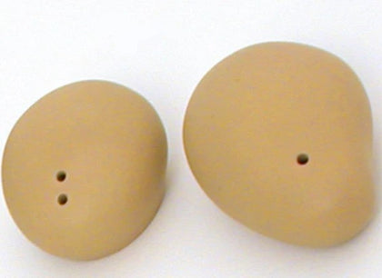 Dijon-colored ceramic salt shakers with a smooth design and small holes on top for dispensing salt.



